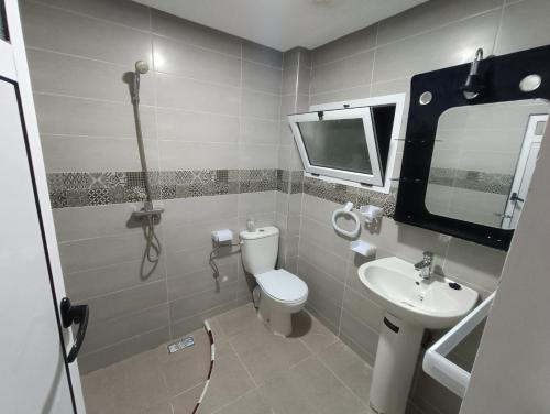 a bathroom with a toilet and a sink at PLAYA HOTEL in Dakhla