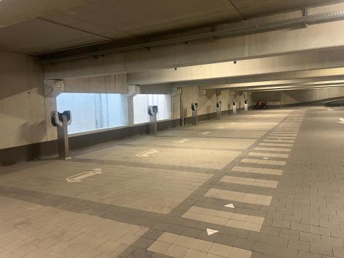 an empty parking garage with parking meters in a building at Helle FeWo am Waldrand - mit Balkon, Pool & Sauna in Freyung