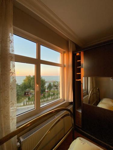 a bedroom with a window with a view of the ocean at Kültür Suite meydan in Trabzon