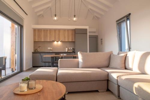 a living room with a couch and a table at Sunset Luxury Villa in Akritokhórion