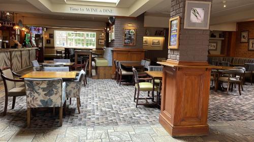 a restaurant with tables and chairs in a room at The Grey Horse in Darlington