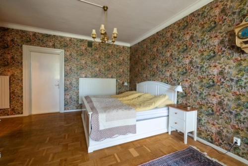 a bedroom with a bed with floral wallpaper at Kläckeberga Bed Not Breakfast in Kalmar