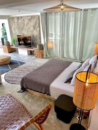 a bedroom with a large bed and a fireplace at Hotel de La Plage - Mahogany in Cassis