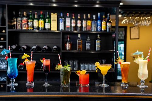 a bar with a bunch of different types of cocktails at Hotel Sarowar Pokhara-Luxury Hospitality in the Heart of Pokhara in Pokhara