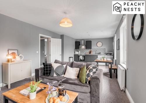 a living room with a couch and a table at Contractor Apartment with Off Road Parking in Norwich