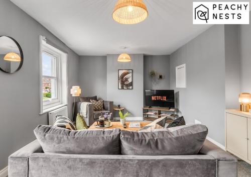 a living room with a couch and a table at Contractor Apartment with Off Road Parking in Norwich