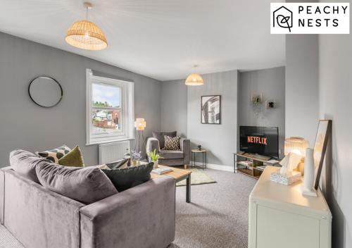 a living room with a couch and a tv at Contractor Apartment with Off Road Parking in Norwich
