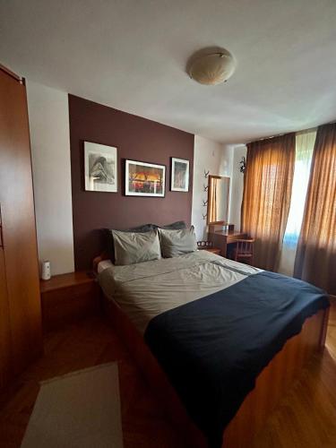 a bedroom with a large bed in a room at Baroque-style apartment in Štip