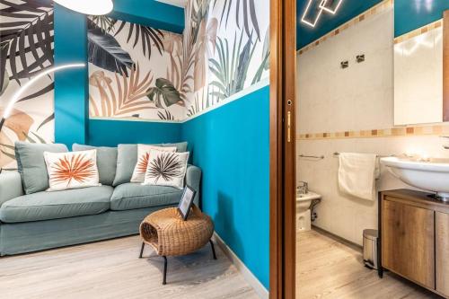 a living room with a couch and a sink at Belmeloro Home in Bologna