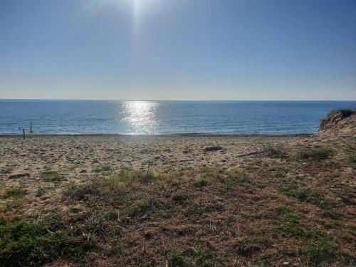 a sandy beach with the ocean in the background at Dolce Relax - Calabria in Catanzaro