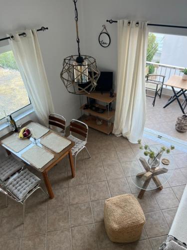 a living room with a table and chairs and a balcony at Ninemia Apartment in Kaloi Limenes