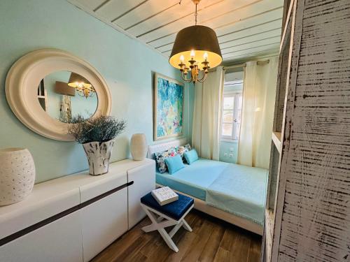 a small bedroom with a bed and a mirror at C Bay in Mýkonos City