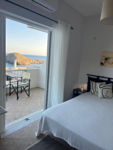 a bedroom with a bed and a view of the ocean at Ninemia Apartment in Kaloi Limenes