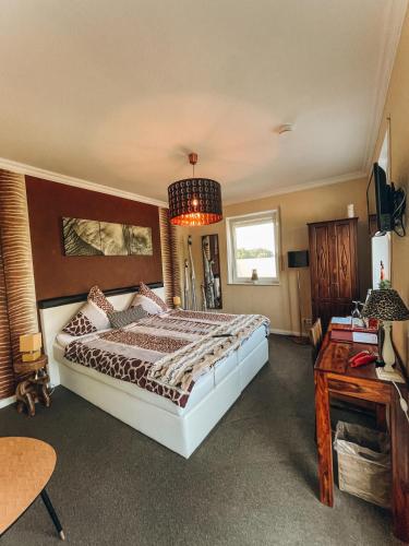 a bedroom with a large bed and a chandelier at RiBecca in Weyhe