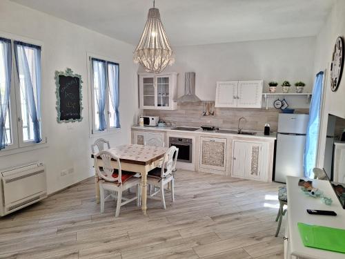 - une cuisine avec une table et des chaises dans la chambre dans l'établissement Blue Wave Apartment, à San Vincenzo