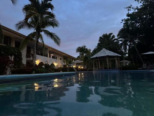 a night view of a swimming pool at a resort at Family 2bd apt near Quepos/Manuel Antonio in Quepos