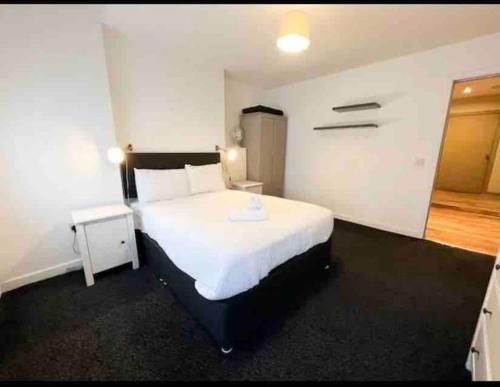 een slaapkamer met een groot wit bed in een kamer bij Modern 2bed 2bath in Leith in Edinburgh