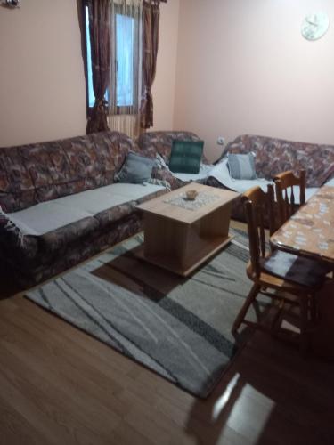 a living room with a couch and a table at Vikendica Jagoš in Mitrovac