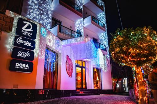 a building with christmas lights on the side of it at Dorana Hotel in Kérynia
