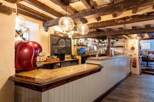 a bar with a wooden counter in a room at Wisteria Hotel in Oakham