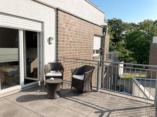 a balcony with two chairs and a table at RiBecca in Weyhe