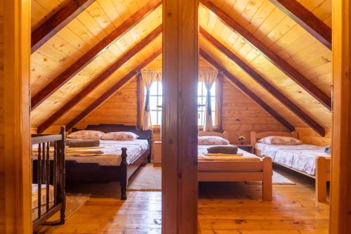 a bedroom with two beds in a attic at Green Hill in Virpazar