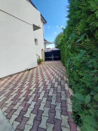 a brick walkway in front of a white building at Appartement meublé avec deux chambres in Moulins