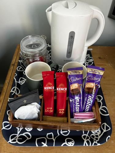 a tray with toothpaste and a blender on a table at Flavian House in Chichester