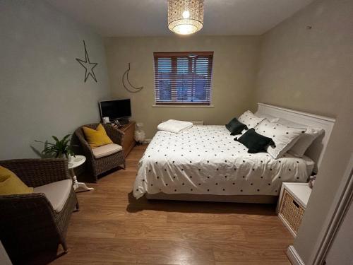 a bedroom with a bed and a couch and a bed at Flavian House in Chichester