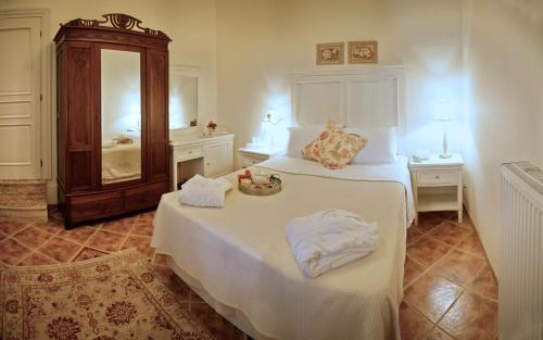 a bedroom with two beds with towels on the bed at Archontiko Petras 1821 in Petra