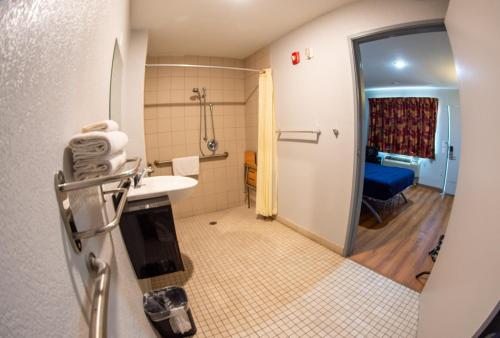 a bathroom with a shower and a sink and a toilet at Anderson Inn, Anderson, Indiana in Anderson