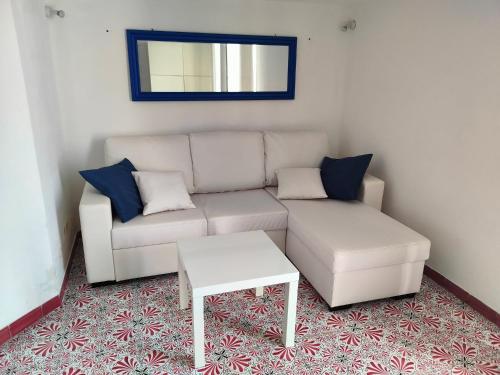 a living room with a white couch and a table at VisitPonza - Olimpo in Ponza