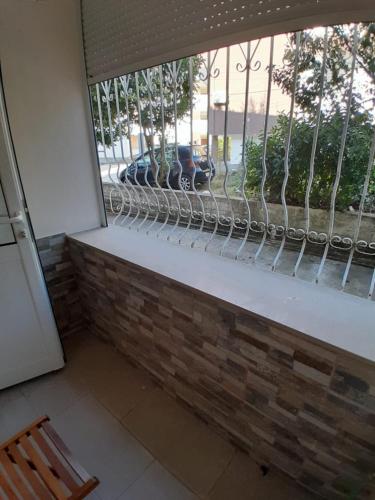 a bench in front of a window with a fence at Guest House Taverna Laberia 2 in Gjirokastër