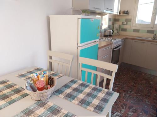 a kitchen with a table with a bowl of utensils at Orizodas in Lipsoi