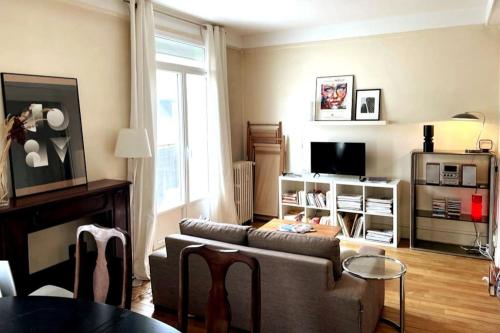 a living room with a couch and a tv at France, Normandie, Rouen Hyper centre, 3 étoiles in Rouen