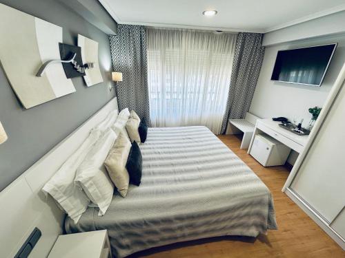 a bedroom with a bed in a room at Hotel Las Olas in Noja
