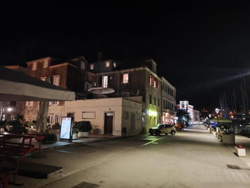 a city street at night with buildings at Luxury Seafront Suite Fabri in Vis