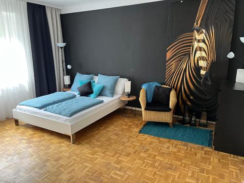 a bedroom with a bed and a chair in it at Apartment Vienna Niko in Vienna