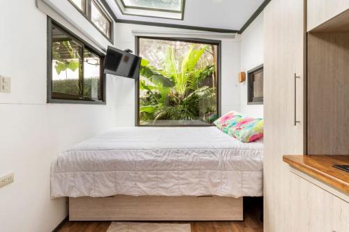 a small bedroom with a bed and a window at Tiny house Monteverde in Monteverde Costa Rica