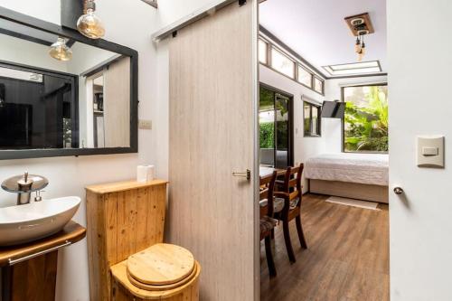 a bathroom with a sink and a bed in a room at Tiny house Monteverde in Monteverde Costa Rica