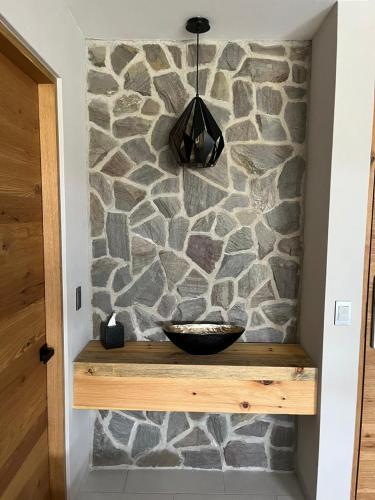 a stone wall with a bowl on a wooden shelf at Casa Agave de Piedra San Miguel de Allende in San Miguel de Allende