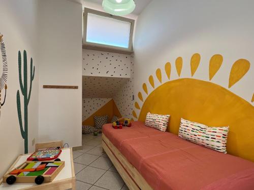 a bedroom with a bed with a large wooden headboard at Livingapple in Scauri