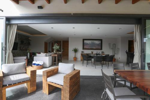 a living room and dining room with a table and chairs at Casa Agave de Piedra San Miguel de Allende in San Miguel de Allende