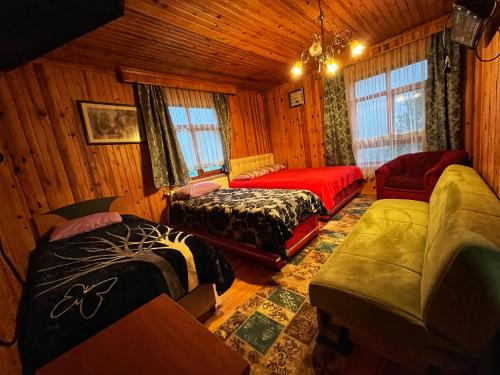 a living room with two beds and a couch at Zirve Apart in Uzungöl