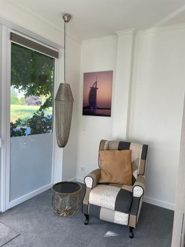 a living room with a chair and a window at RiBecca in Weyhe