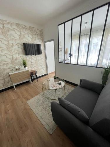 un salon avec un canapé et une table dans l'établissement Magnifique T1 Bis entièrement refait à neuf, à Canet