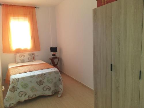 a small bedroom with a bed and a window at Cal Cucu in Gerp