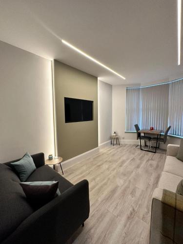 a living room with a couch and a table at Glasgow West End Tenement Apartment in Glasgow