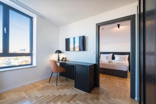 a bedroom with a bed and a desk and a mirror at Miramare Hotel in Zadar