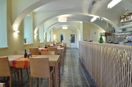 a restaurant with a row of tables and chairs at Hostel Lípa - Továrna in Krásná Lípa